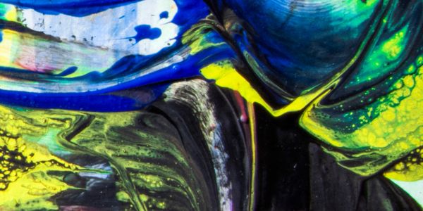 Vibrant abstract painting with swirling blue, yellow, green, and black colors.