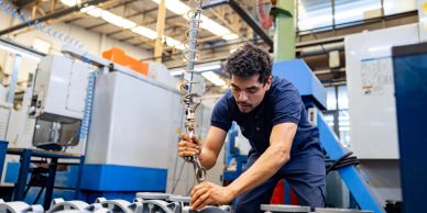 A man working with machinery in a factory.