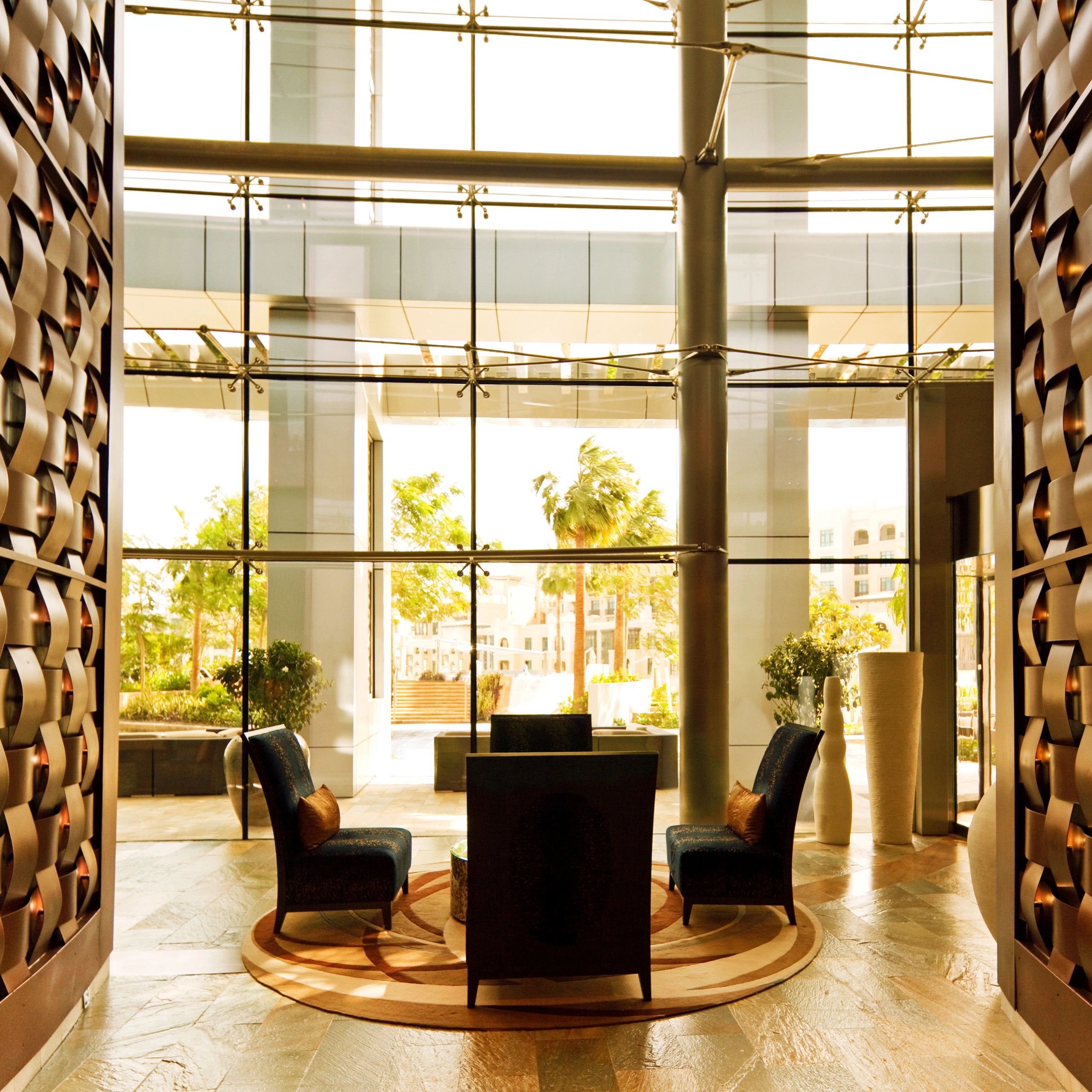 Elegant lobby seating area with large glass windows and natural light.
