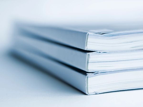 Close-up of three stacked magazines.
