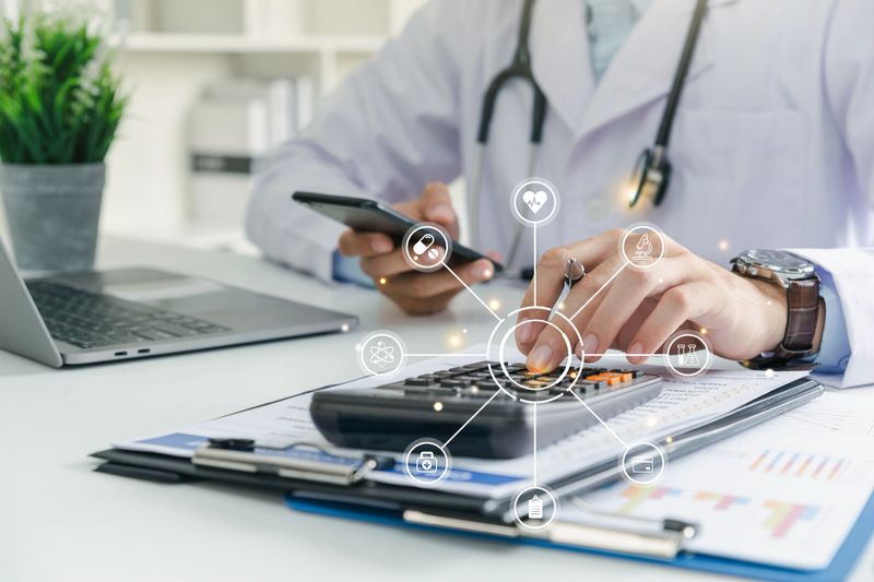 Doctor physician calculate medical healthcare fee costs and revenue, Practitioner using calculator at clinic.