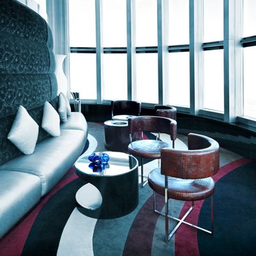 Modern lounge area with curved seating and large windows.