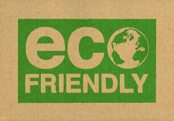 Eco friendly sign with earth illustration on cardboard background.