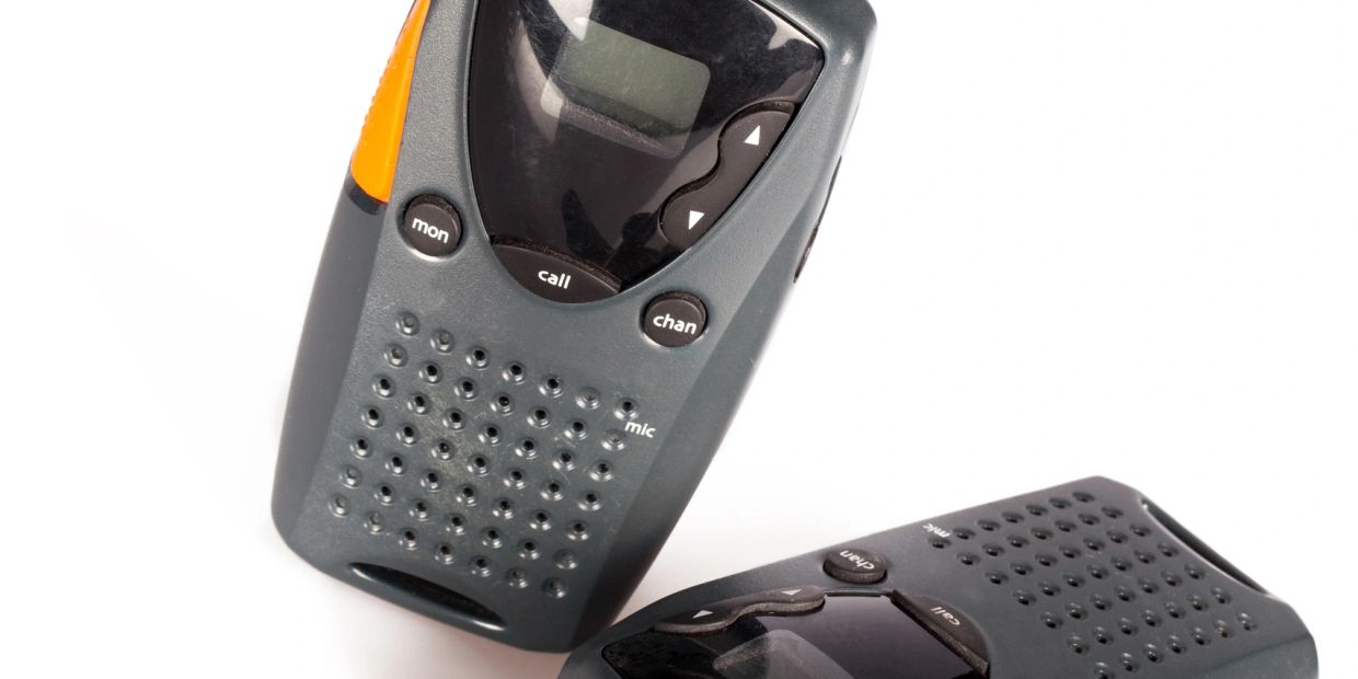 Two handheld walkie-talkies on a white background.