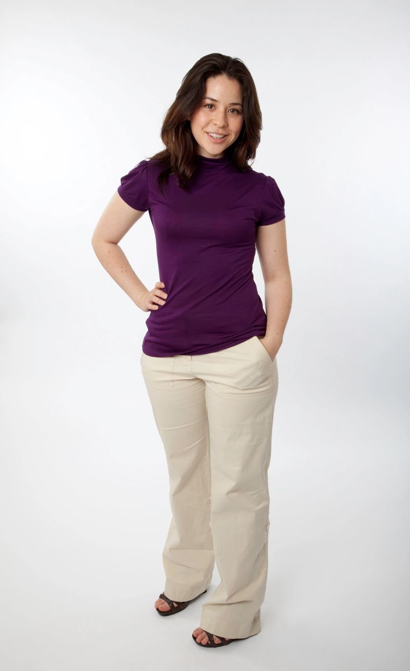 Young woman standing and looking with hand on hip