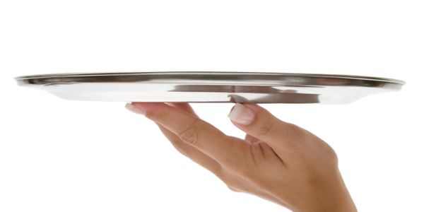 Hand holding an empty silver serving tray against a white background.