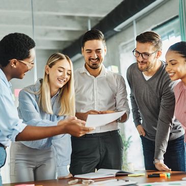 Diverse young professionals celebrating success during a collaborative workplace training session
