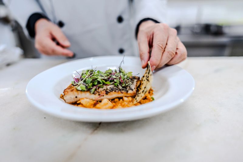 Close-up of a chef preparing a gourmet dish at commercial kitchen