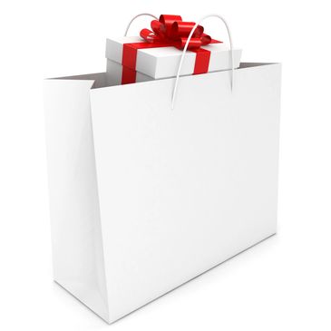 White gift bag with a white present wrapped in red ribbon inside.