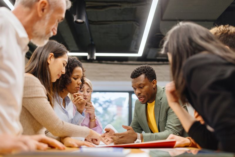 Motivated group of people working on a project in the modern office