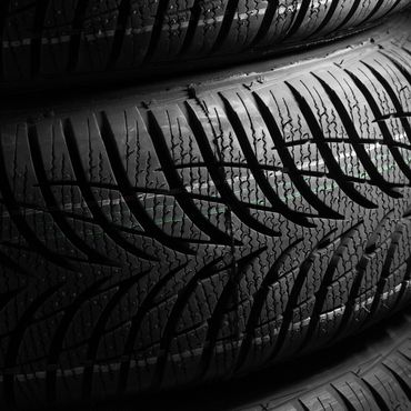 Close-up of detailed new tire treads with sharp patterns.