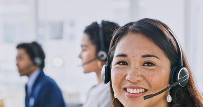 Smiling customer service representative with headset.