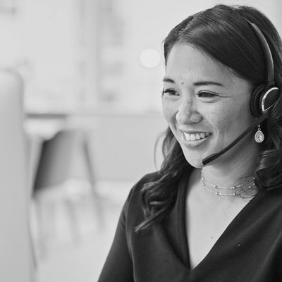 A woman with headphones working as a virtual assistant
