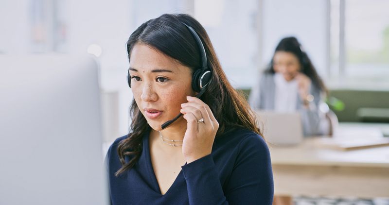 Business, telemarketing or woman with call center, conversation or communication. Person, consultant or agent with headphones, telecom sale or customer service with tech support or crm with help desk