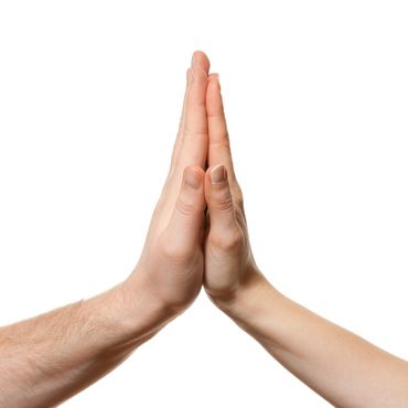 Two hands pressed together in a high-five gesture on a white background.