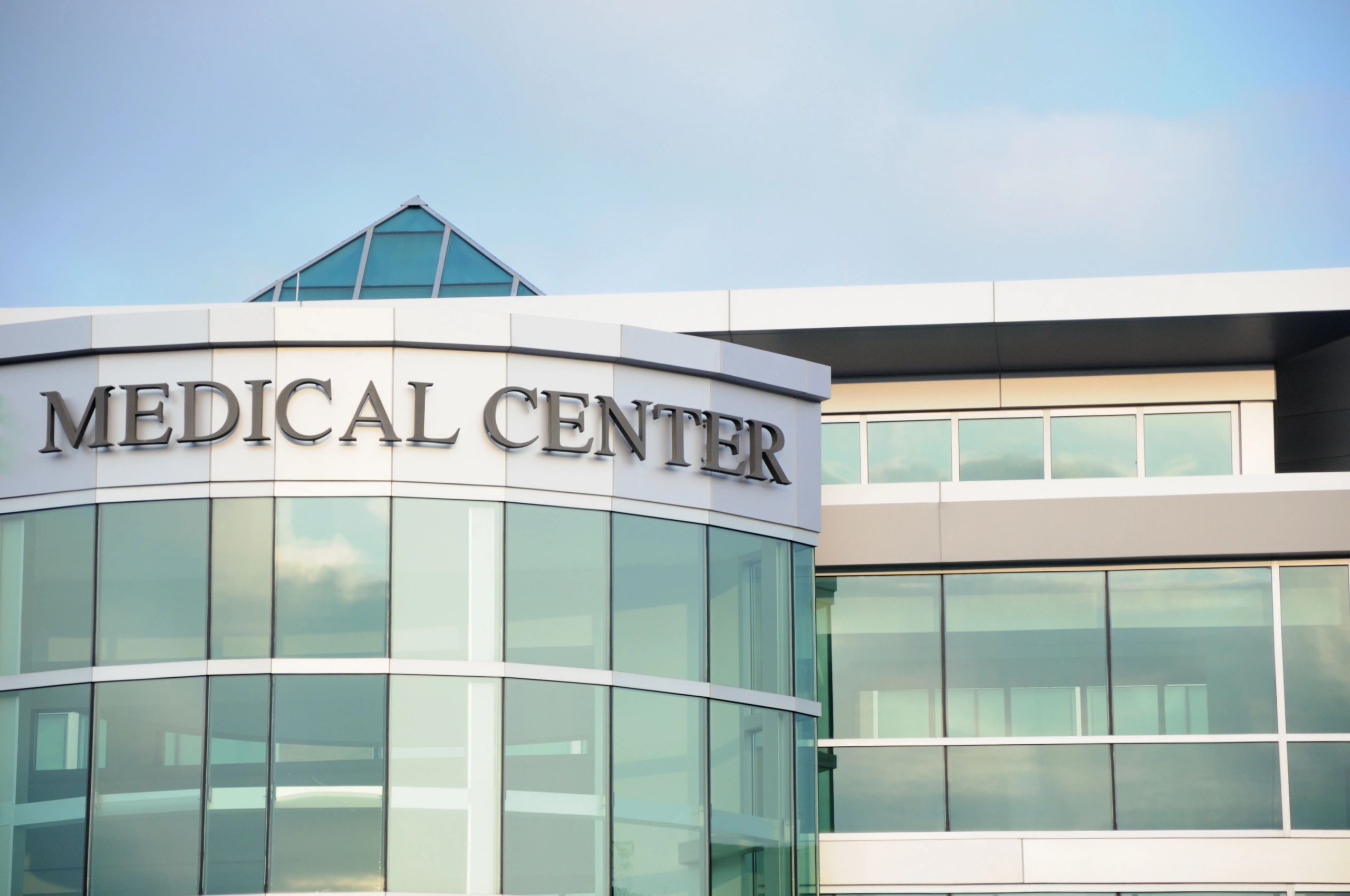 Modern medical center building with glass windows.