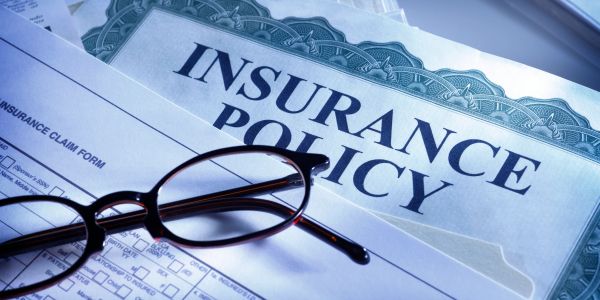 Insurance policy documents with glasses.