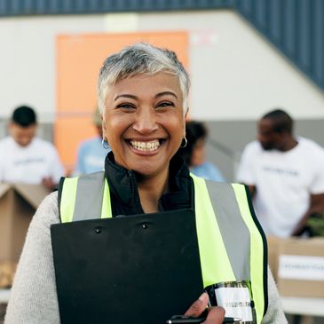 A woman much smiling and looking on the camera