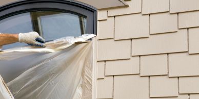 Person removing protective plastic from a window.