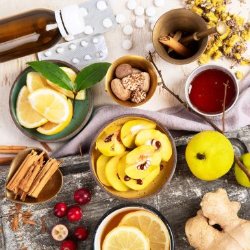 Natural remedies and ingredients arranged with medicine tablets and bottles.