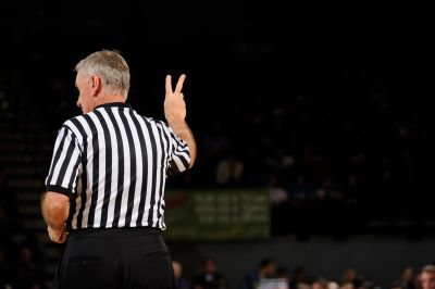 Sports referee signaling with two fingers.
