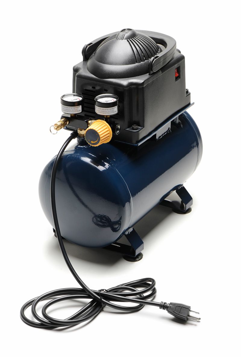 "Blue and black portable air compressor with power cord,  isolated on white. Other picture..."