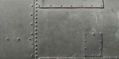 Close-up of metal panel with rivets.