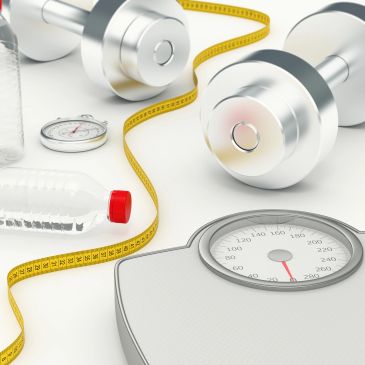 Fitness equipment including dumbbells, scales, and measuring tape.
