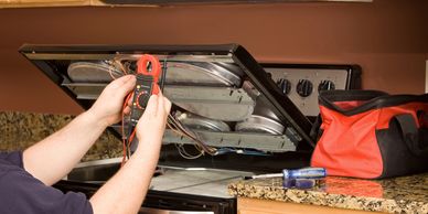 Certified technician performing stove and range repair in Winnipeg. Expert appliance service 