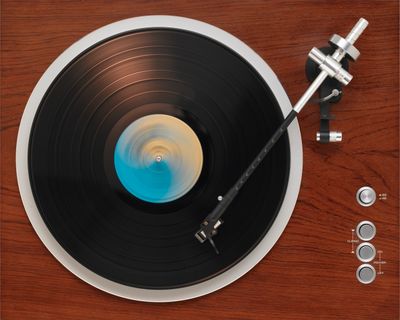 Close-up of a cymbal and blurred drum set in the background.