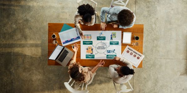 Team planning SEO strategies around a table.