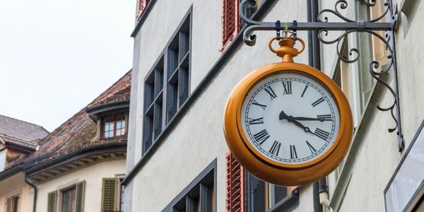 A large round clock with Roman numerals.