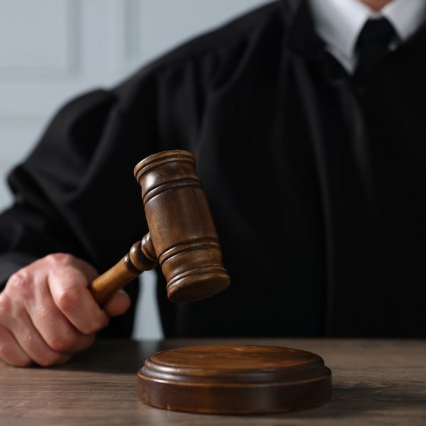 A judge getting ready to pound his gavel. 