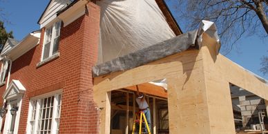 Contractor working on the wood framing of a new home addition.
