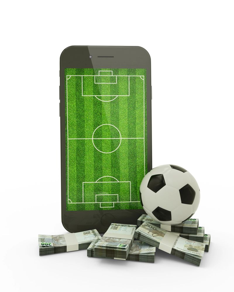 3D rendering of a mobile phone with soccer field on screen, soccer ball and stacks of Brazilian rial notes isolated on white background.