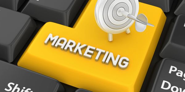 Yellow marketing key with a target and arrow on a keyboard.