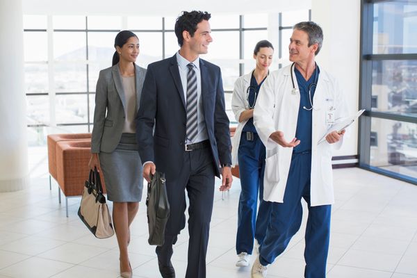 Doctors and business professionals walking and talking.