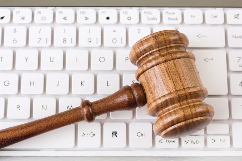 Wooden gavel on white keyboard