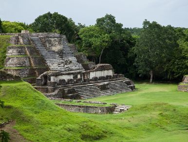 Ancient Mayan pyramid with lush greenery.