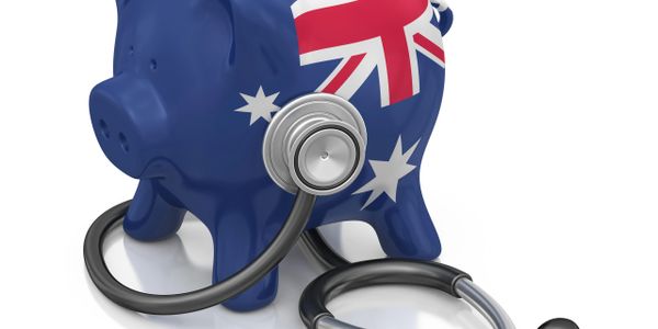 Piggy bank with Australian flag and stethoscope symbolizing healthcare finance.