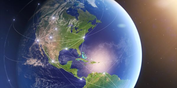 Glowing network connections radiate from the United States across a digital Earth.