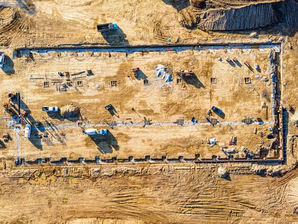 Aerial view of a construction site with machinery and groundwork.