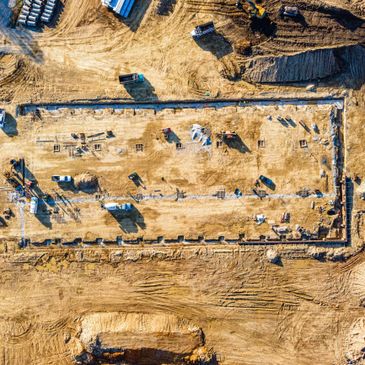 Aerial view of a construction site with machinery and groundwork.