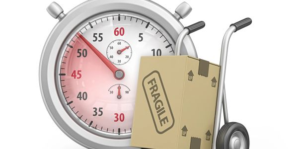 Stopwatch with fragile package on a hand truck.