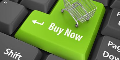 Green 'Buy Now' keyboard key with shopping cart.