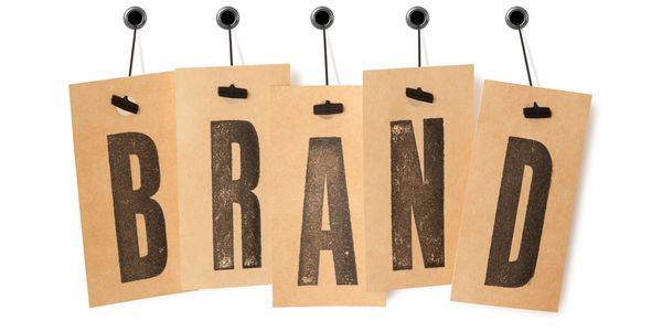 Brown cards spell out the word 'BRAND' hanging on strings.