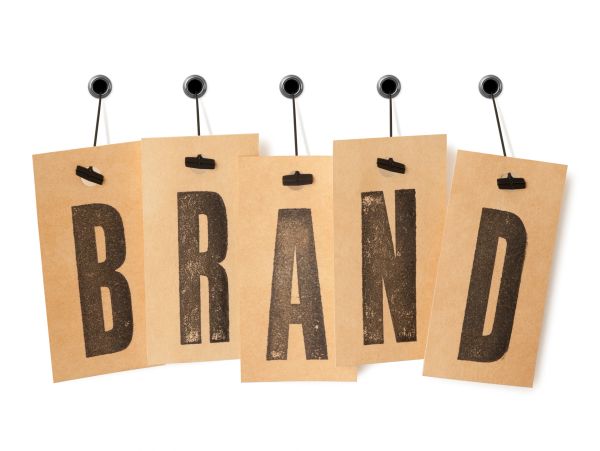 Brown cards spell out the word 'BRAND' hanging on strings.