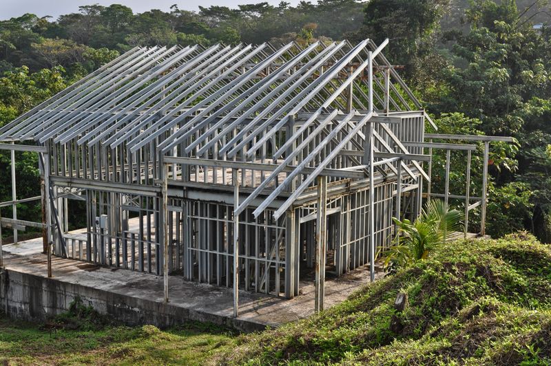 New home contruction site using steel frame. Residential homes built with steel and concrete in a wet humid climate.