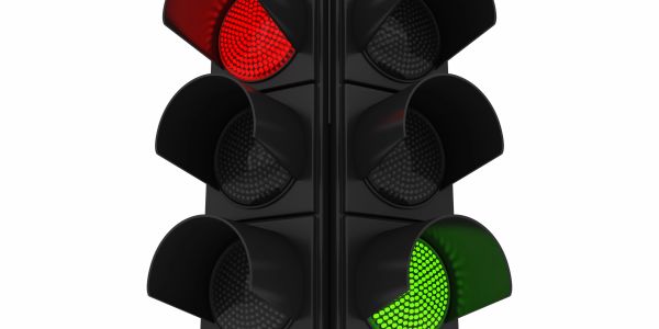 A traffic light showing red and green signals.