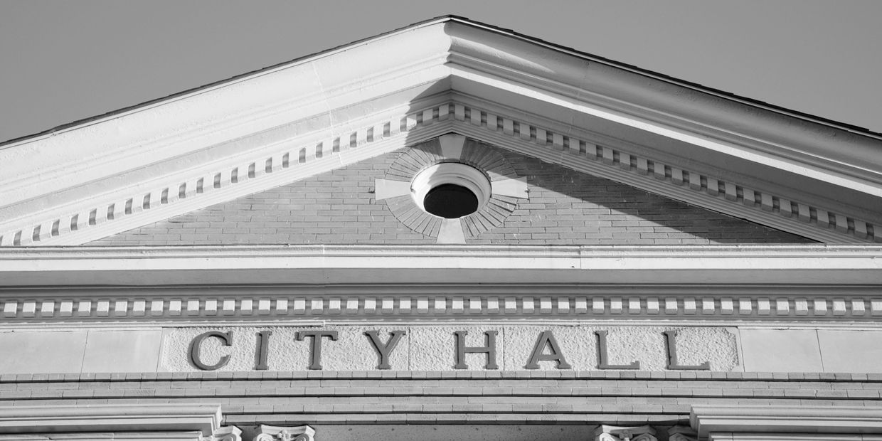 Close-up of a city hall building facade with classical architectural details.